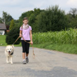 girl walking dog