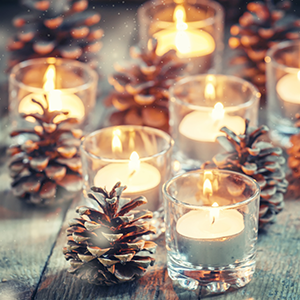 holiday candles and pine cones