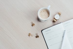 goal notebook on a desk with coffee