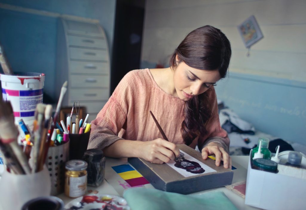 artist in her organized art studio