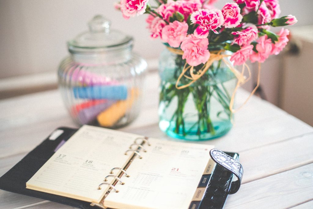 agenda on desk with flowers