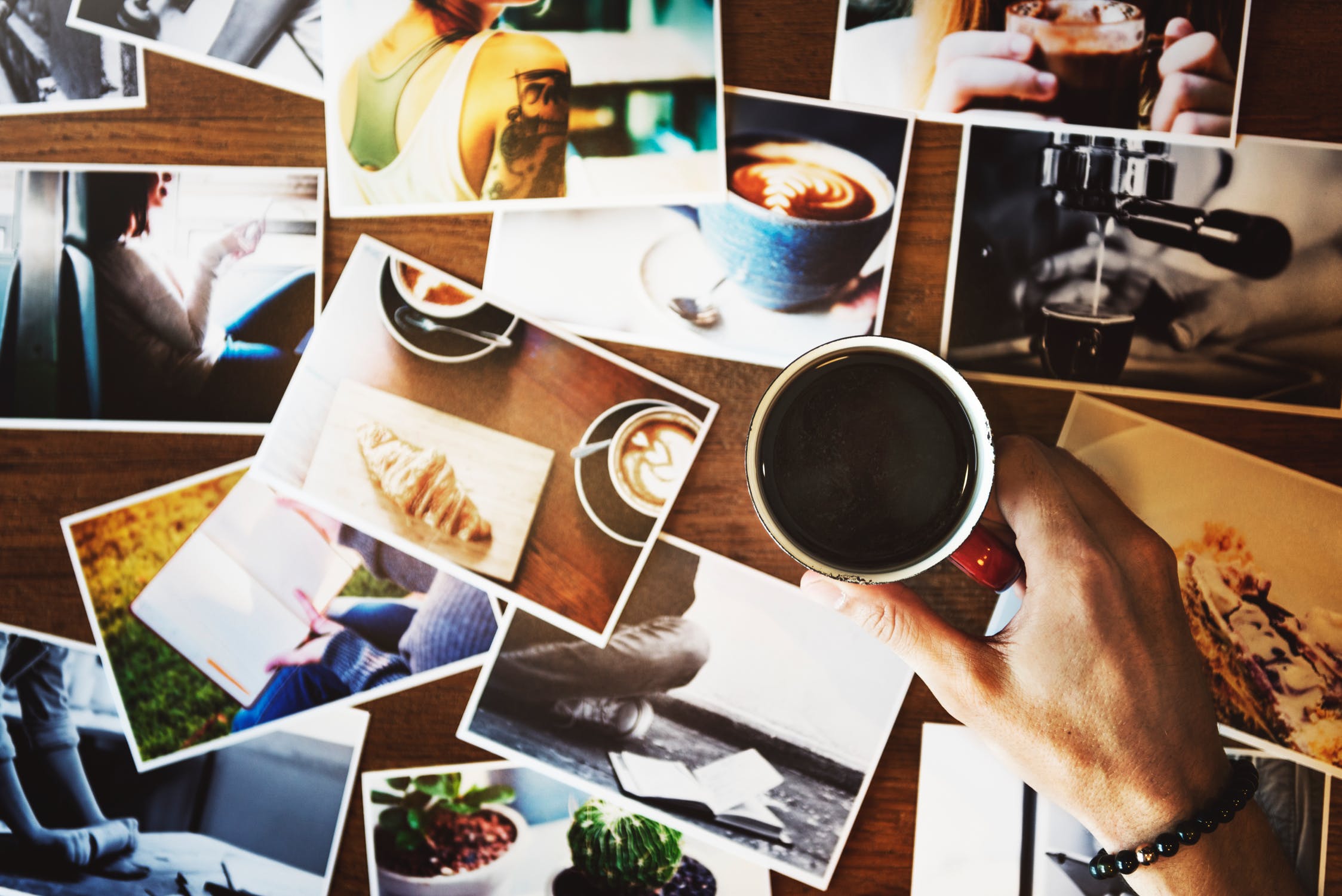 photos on table with coffee cup