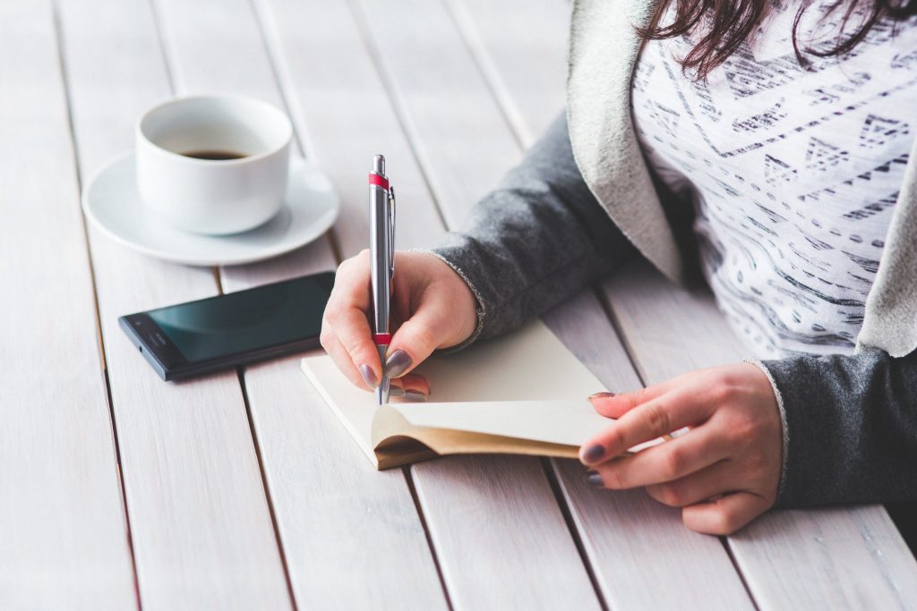 woman writing wish list for new home