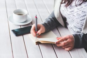 woman writing wish list for new home