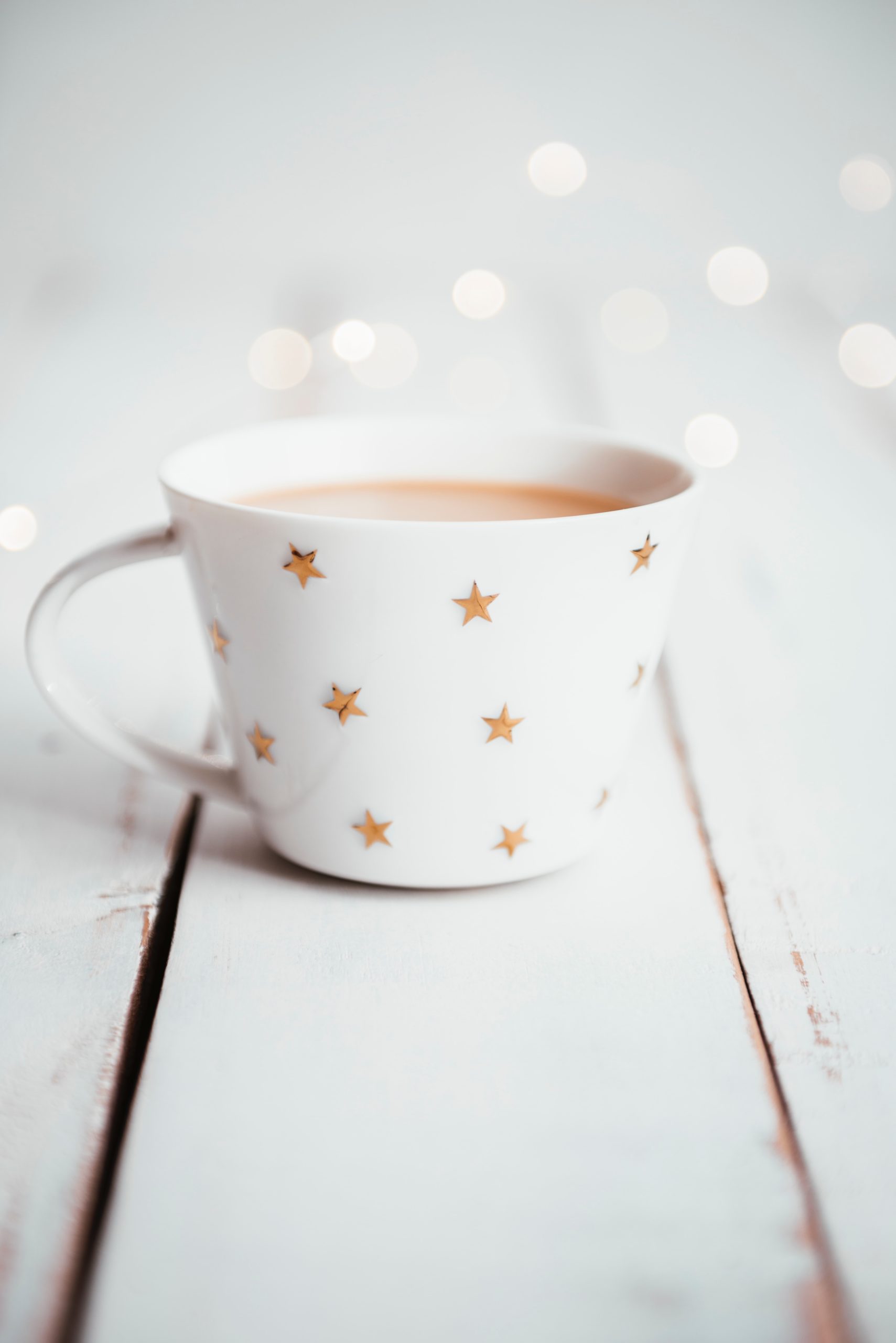soothing cup of tea in star mug on white table