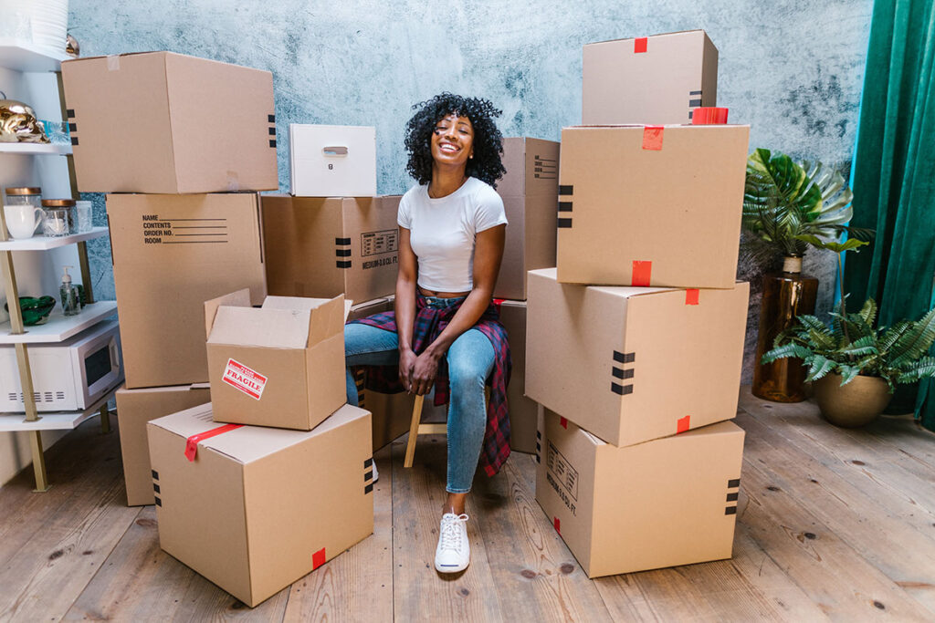 Moving Concierge surrounded by moving boxes