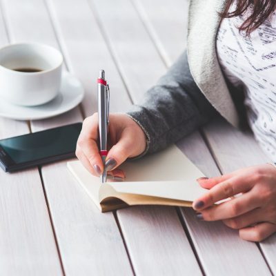 woman writing wish list for new home